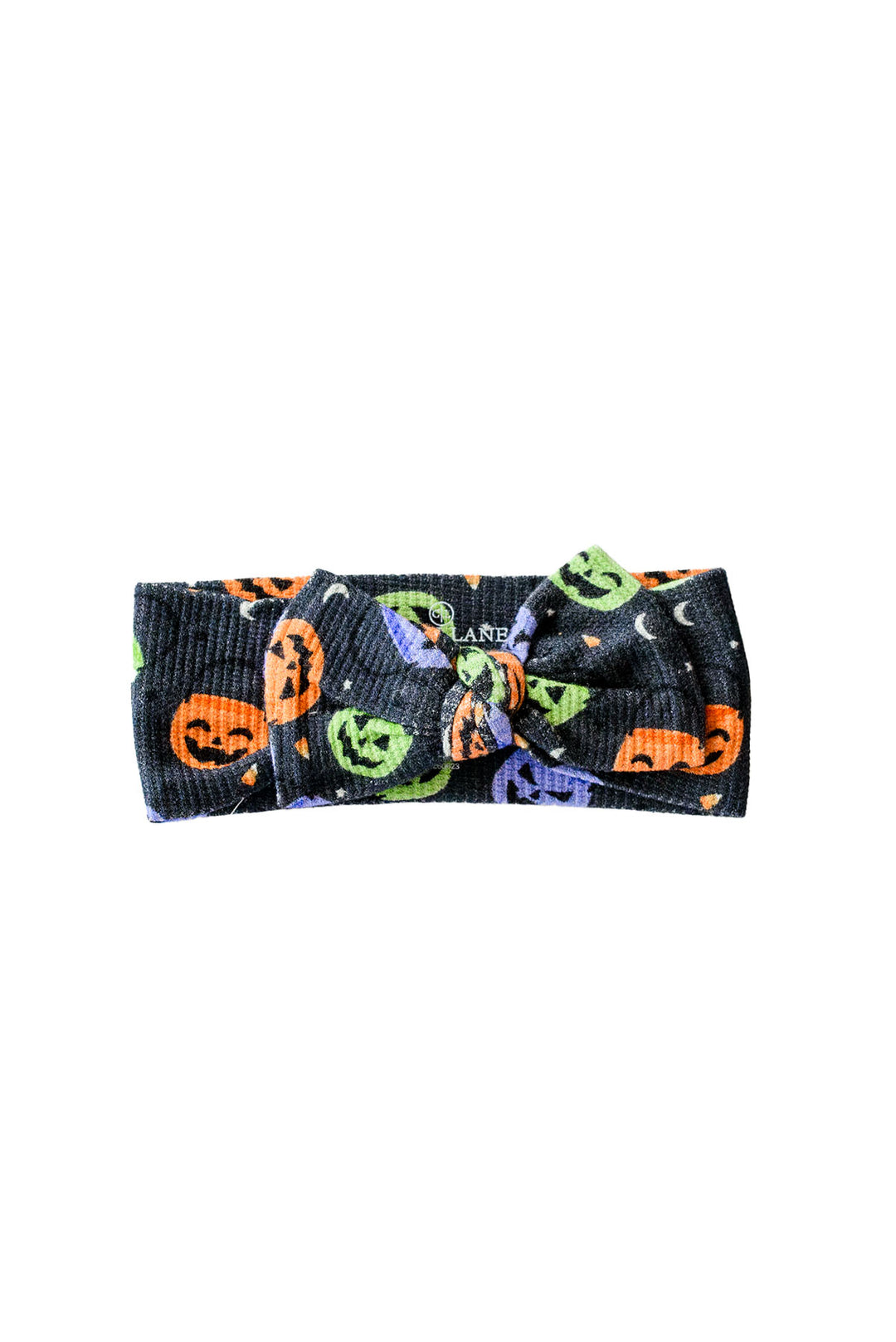 Bamboo waffle knit bow headwrap in black with colorful jack-o-lantern print, tied in a knot