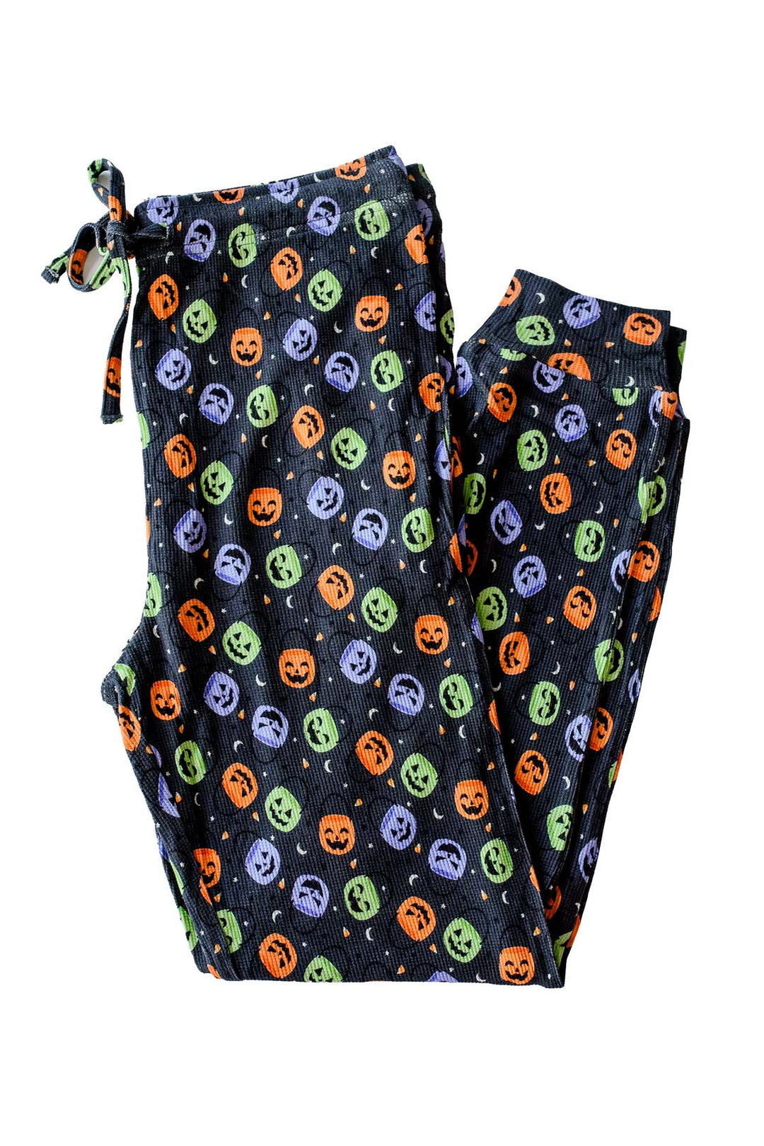 Bamboo waffle jogger pajama pants in black with colorful jack-o-lantern candy print, folded with drawstring tied