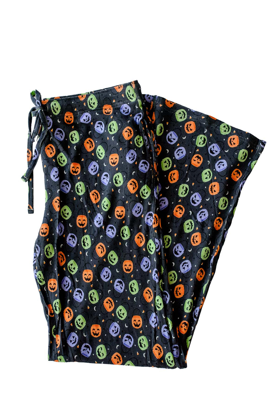 Bamboo waffle lounge pajama pants in black with colorful jack-o-lantern candy print and drawstring waist, laid flat