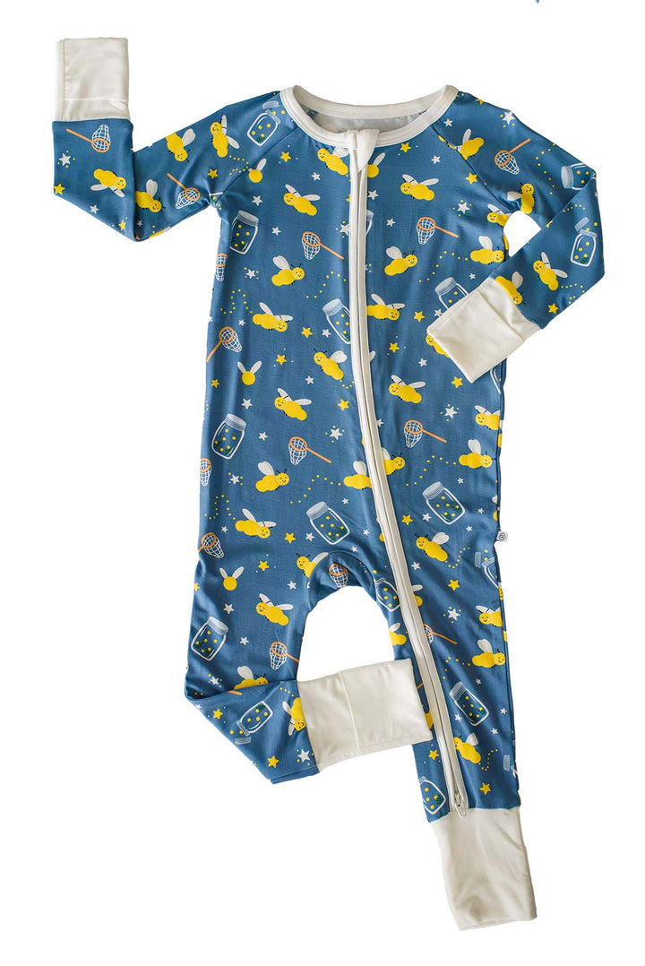 Flat lay of a Caden Lane blue convertible bamboo zip romper in a Chasing Fireflies print featuring fireflies and mason jars, with one mitten and one foot cuff folded closed.