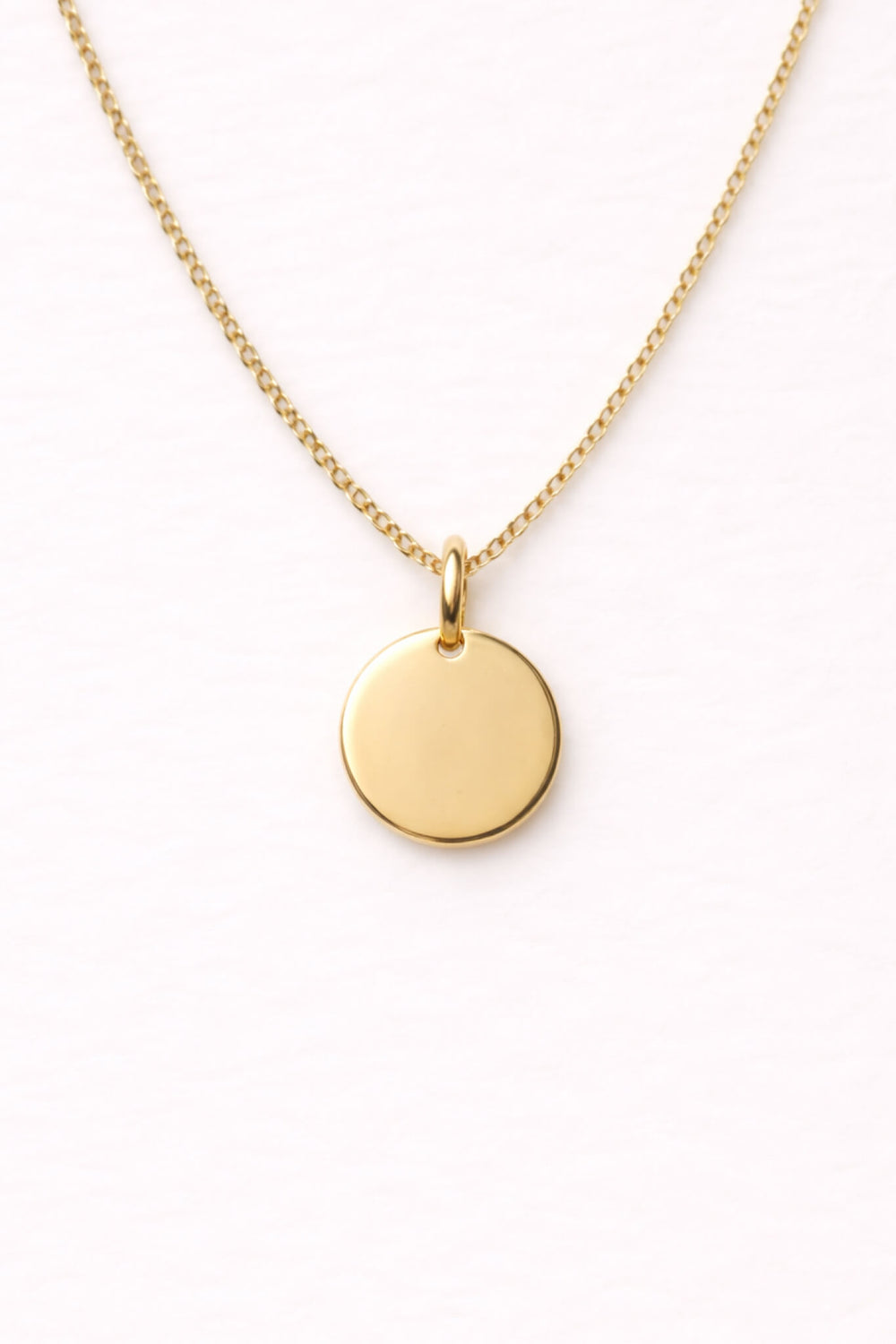 Caden Lane gold curb chain necklace with a blank engravable circle disc pendant