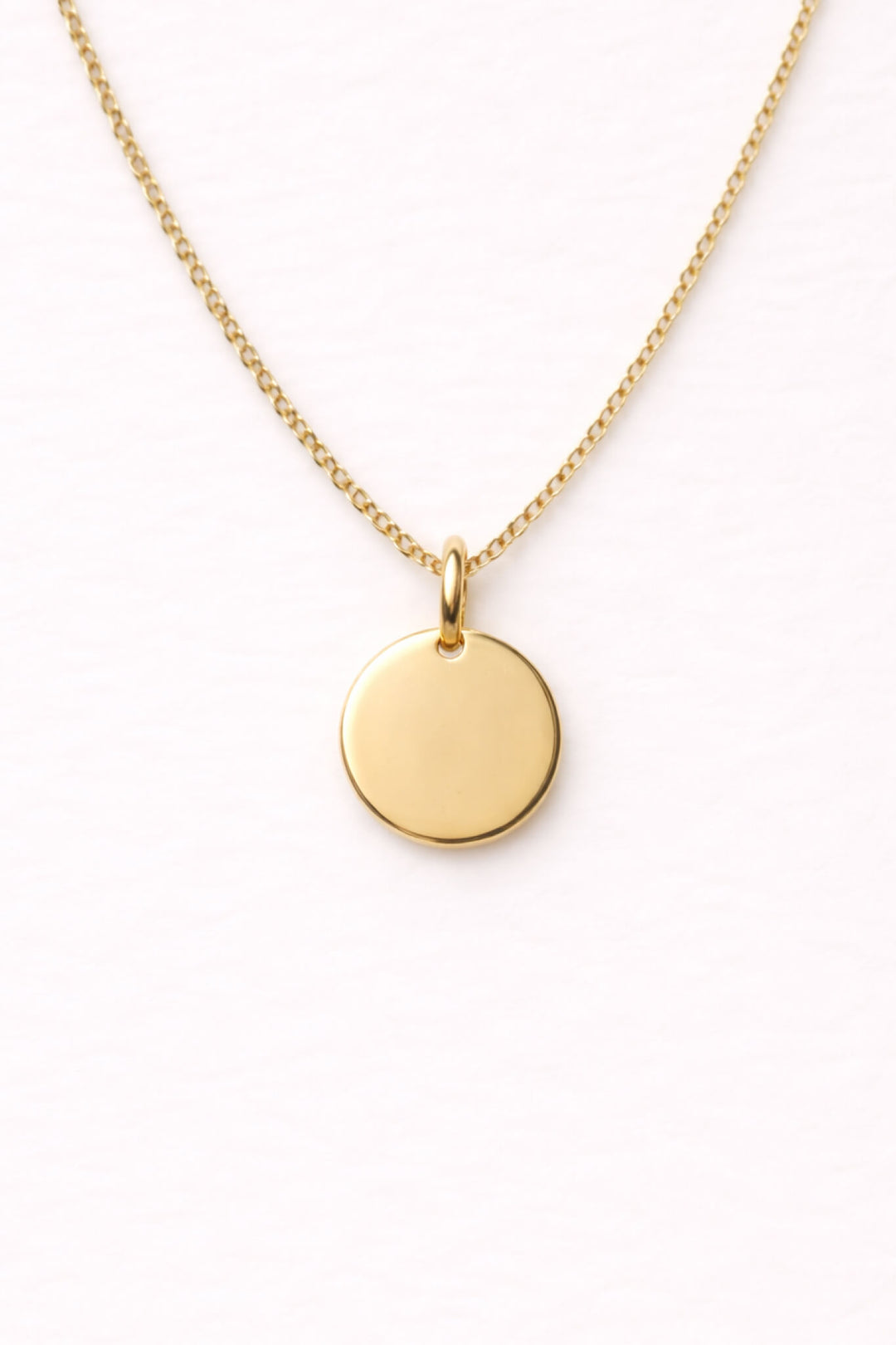 Caden Lane gold curb chain necklace with a blank engravable circle disc pendant