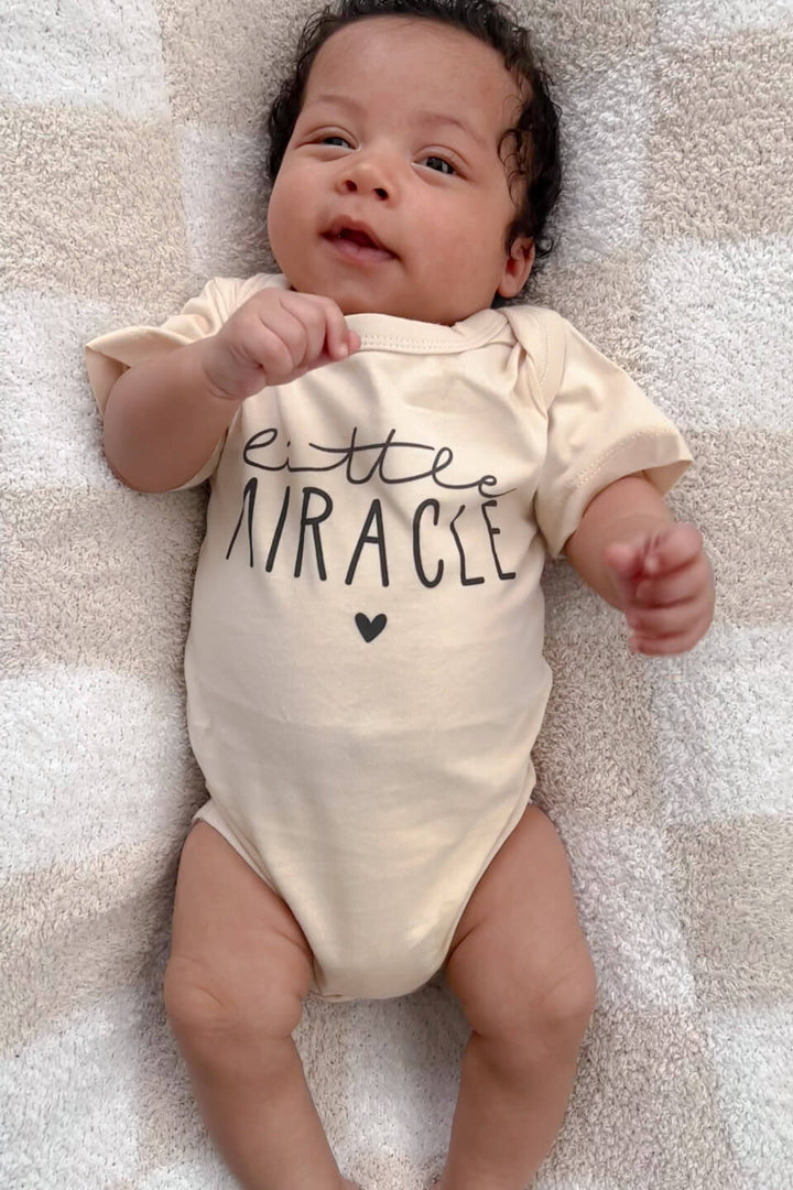 newborn in personalized little miracle cotton bodysuit, celebrating the ivf journey and new beginnings