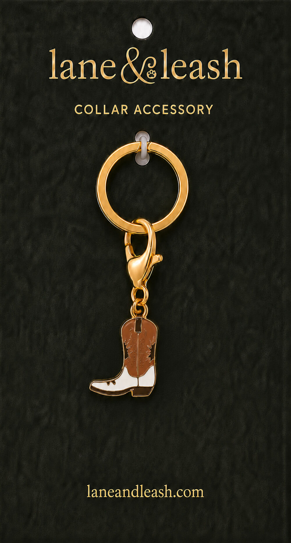 Brown and white cowboy boot Lane & Leash collar accessory charm displayed on dark green packaging card with lobster claw clasp and jump ring