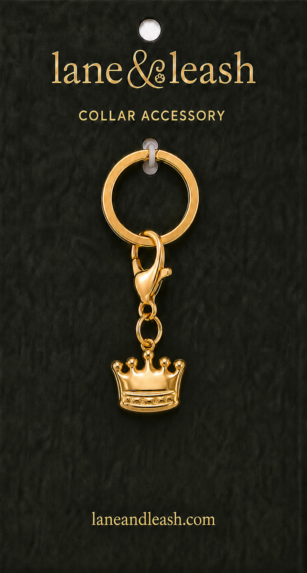 Gold crown Lane & Leash collar accessory charm displayed on dark green packaging card with lobster claw clasp and jump ring