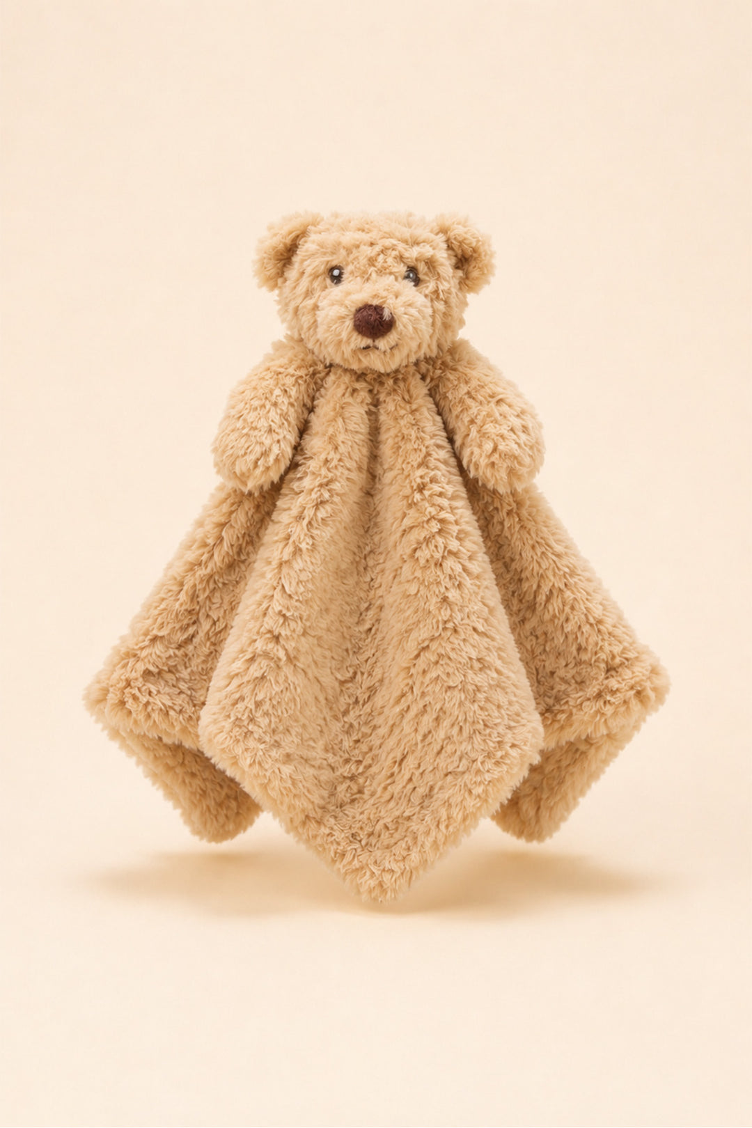 A Caden Lane plush teddy bear security blanket with a soft, textured beige fabric body, photographed against a solid cream background.