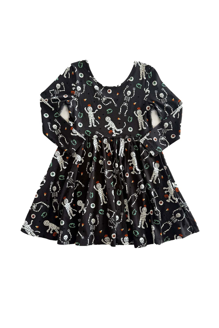 Caden Lane black long-sleeve Halloween dress with a twirl skirt, featuring a white skeleton, mummy, and candy corn print