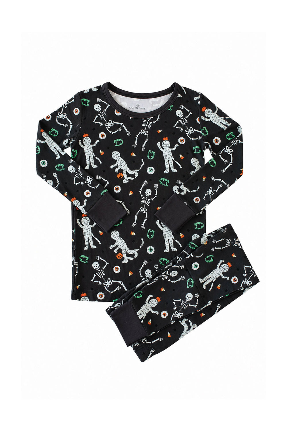 Caden Lane black two-piece pajama set with a white skeleton, mummy, and candy corn print