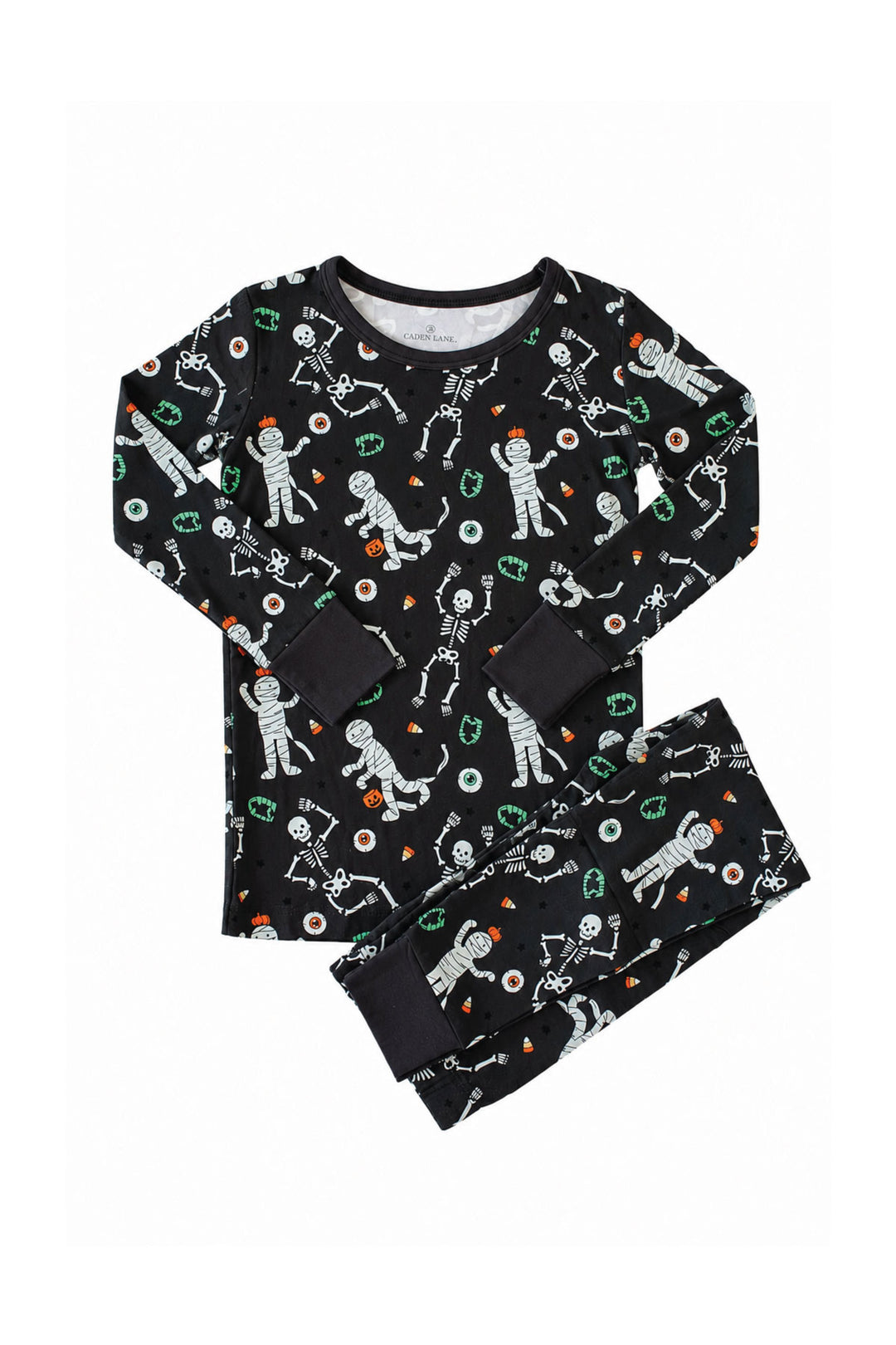 Caden Lane black two-piece pajama set with a white skeleton, mummy, and candy corn print