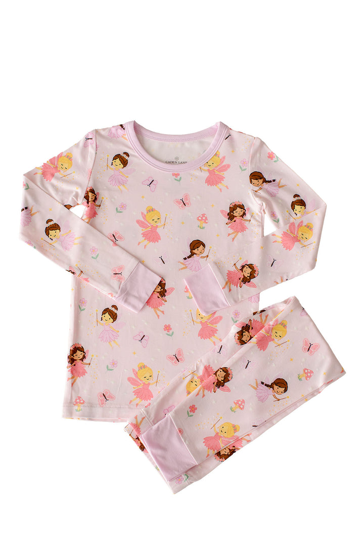 Flat lay of the Fairy Wishes glow-in-the-dark bamboo pajama top and pants with pink cuffs and all-over fairy print