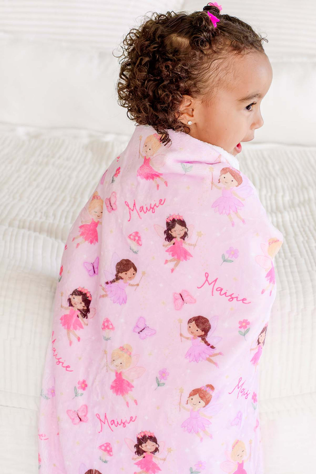 Side view of a toddler wrapped in the Fairy Wishes personalized kids&