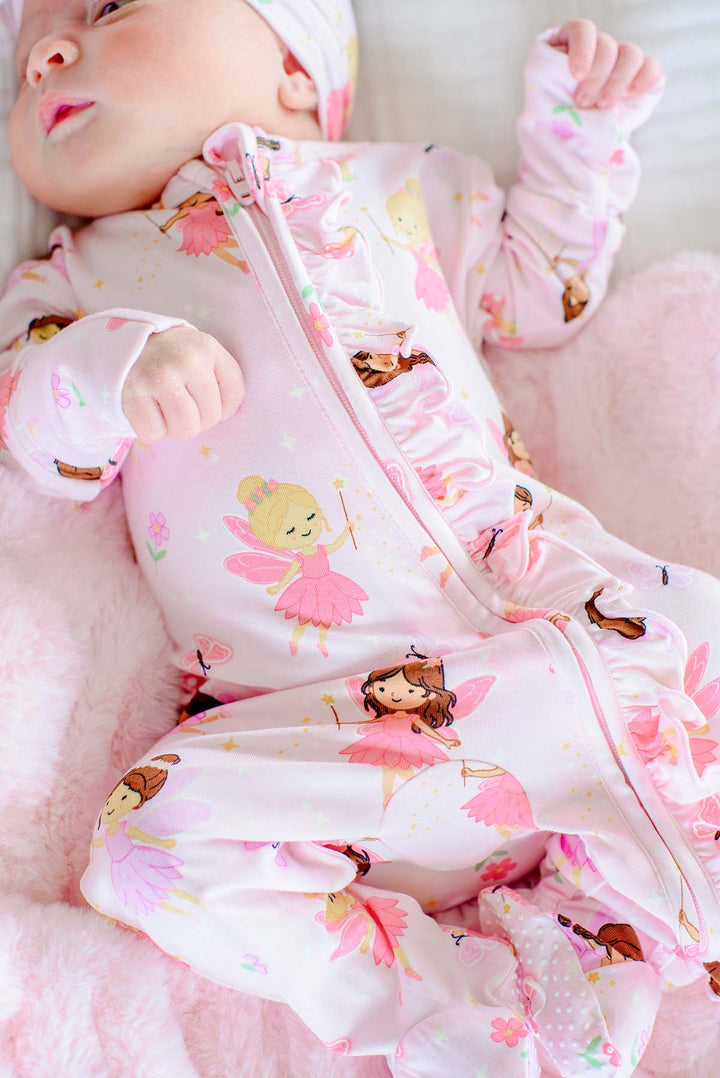Baby wearing the Fairy Wishes glow-in-the-dark zipper ruffle footie, showing the two-way zipper and ruffle detail