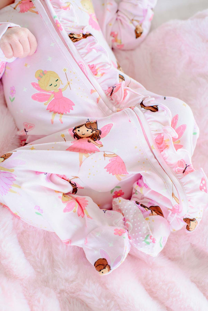 Close-up of the Fairy Wishes glow-in-the-dark zipper ruffle footie showing the fairy print, ruffle trim and footed legs