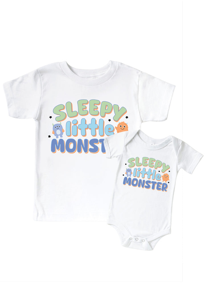 Caden Lane matching white "Sleepy Little Monster" t-shirt and onesie set with green, blue, and orange monster graphic and star accents