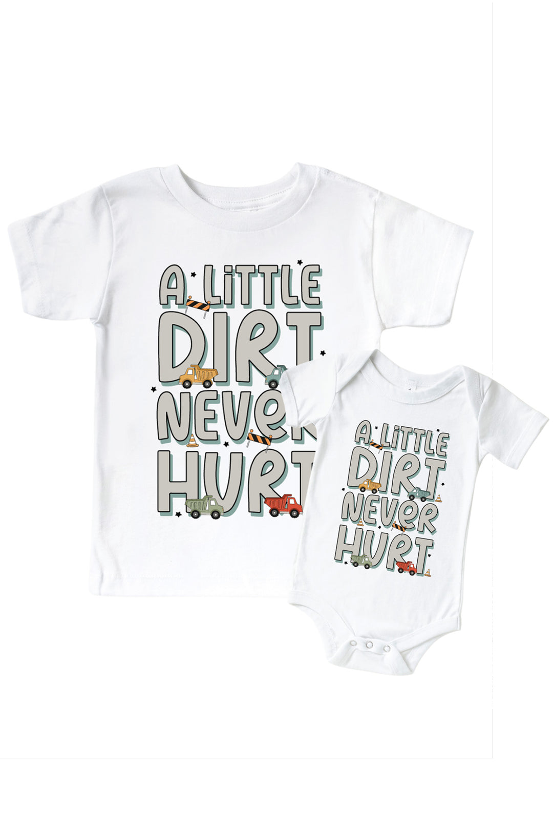 Flat lay of a Caden Lane white tee in a Busy Builder print featuring dump trucks, cones, and barricades, reading "A little dirt never hurt," paired with a matching bodysuit.