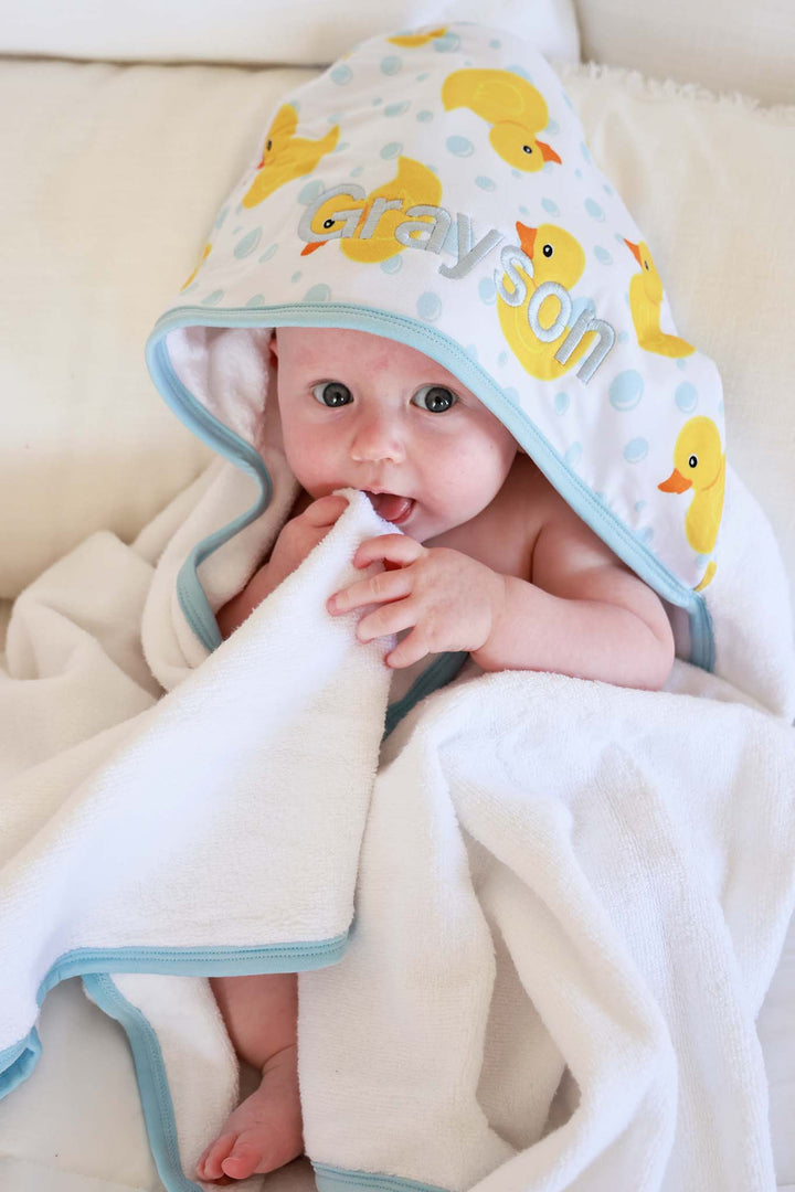 baby wrapped in rubber duck embroidered towel