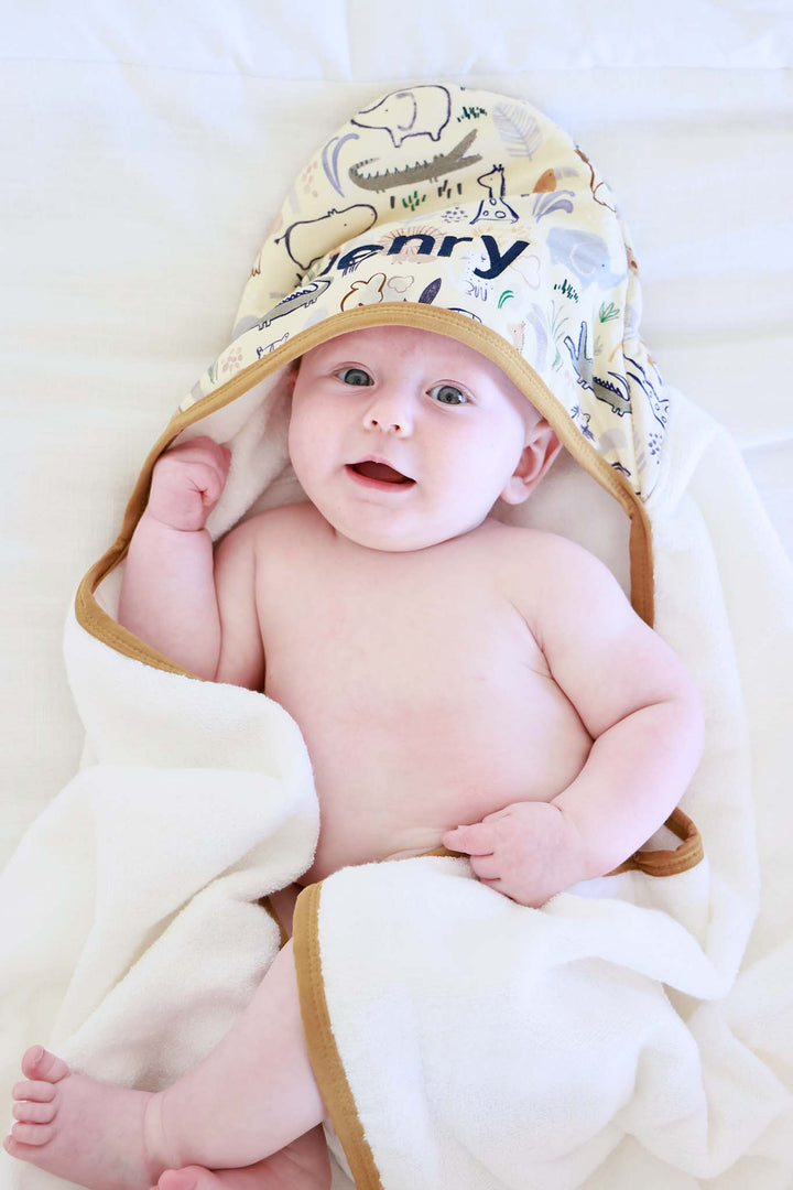 baby wrapped in embroidered hooded towel in into the wild print 