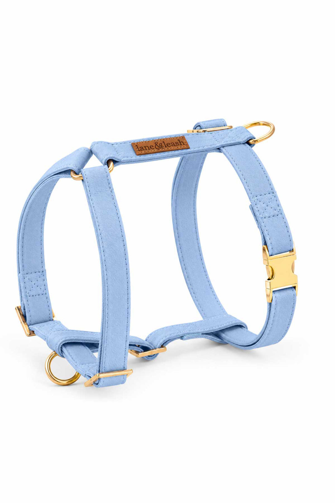 Caden Lane denim days light blue strap dog harness with H-style design and gold hardware, on white background
