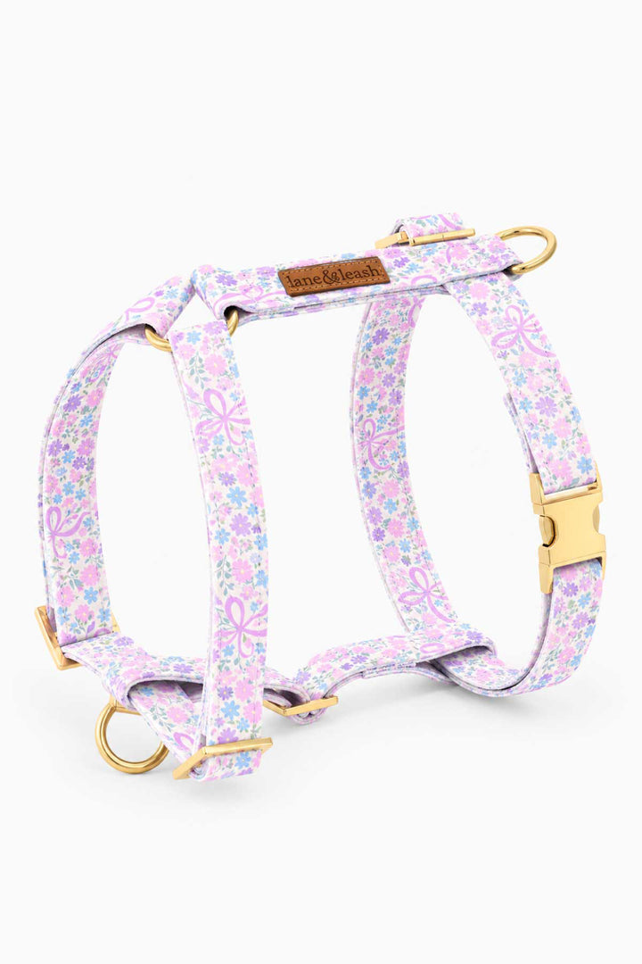 Ribbon Garden strap dog harness — H-style design in pink and lavender floral print with gold hardware and D-ring attachment points — shown flat on white background