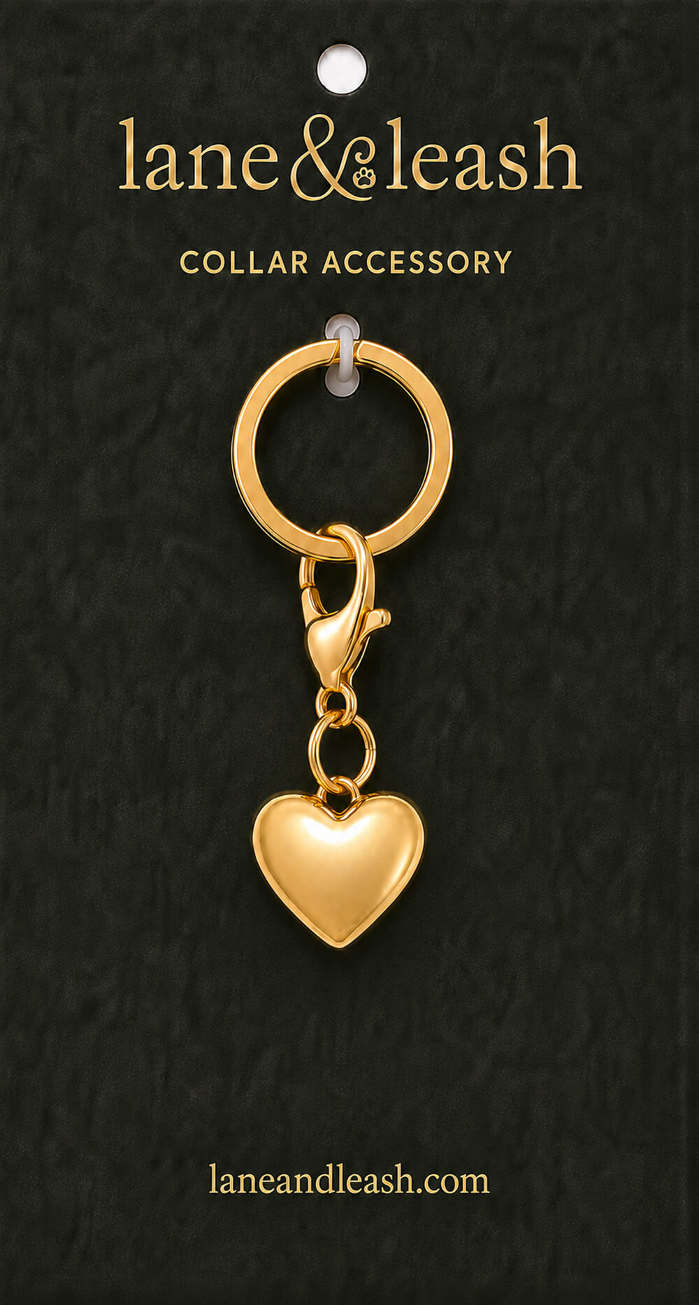 Gold heart Lane & Leash collar accessory charm displayed on dark green packaging card with lobster claw clasp and jump ring