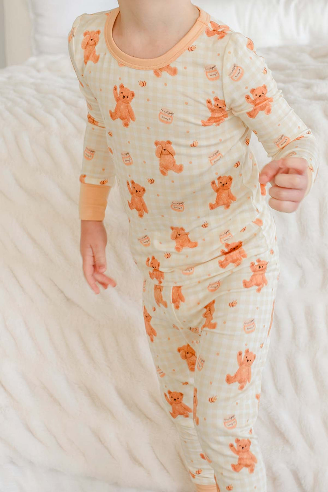 Toddler wearing a Caden Lane honey bear print two-piece pajama set
