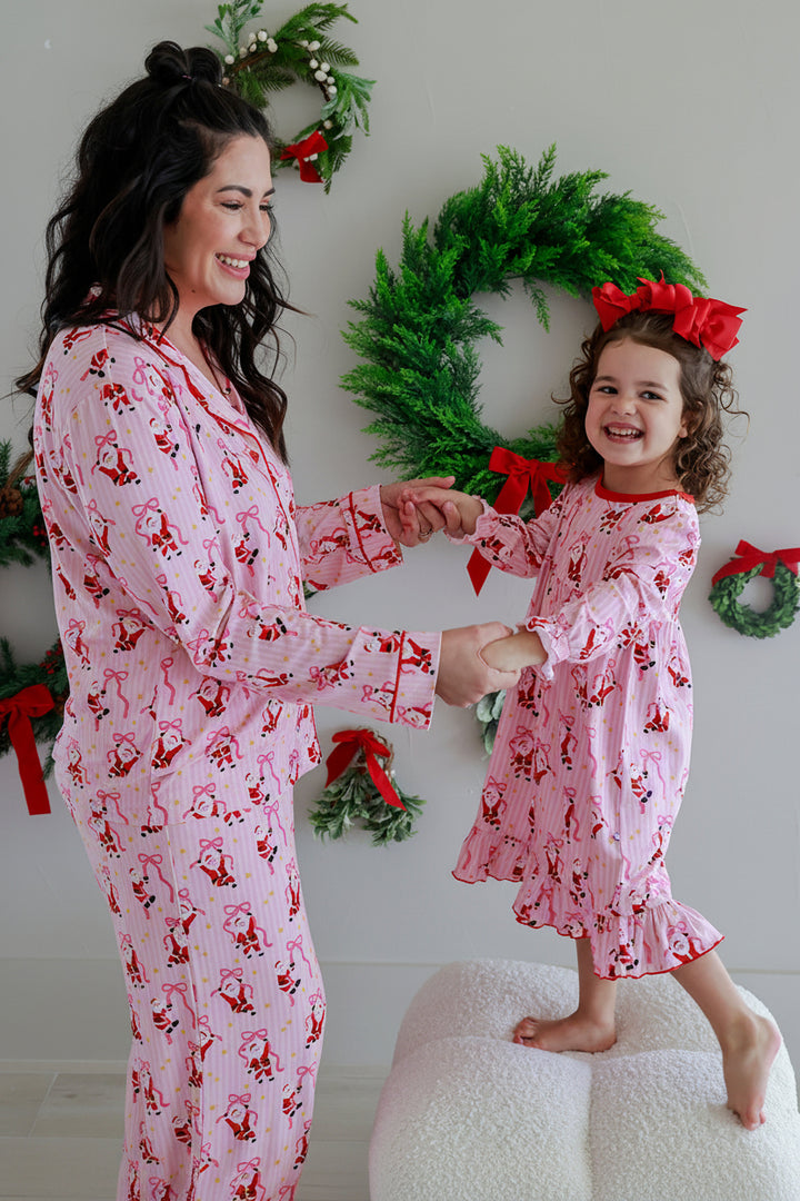 Mother and daughter wearing matching Caden Lane Jolly Ribbons Christmas pajamas and girls' long sleeve nightgown for cozy holiday family photos.