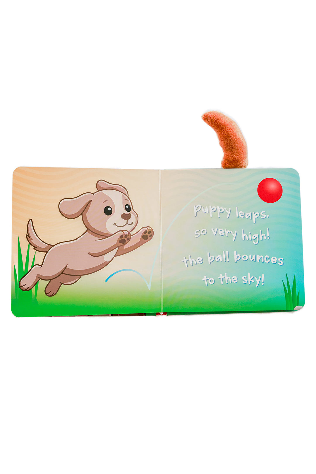 Little Puppy Plays Cuddle Plush Friends Story Book open pages showing a leaping puppy chasing a red ball with text about playing