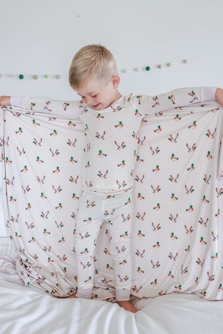 Little mallard duck print double-sided bamboo blanket folded showing print exterior and plain cream reverse side
