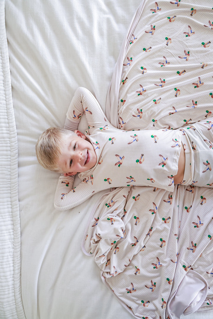 Little mallard duck print double-sided bamboo blanket folded with corner fold showing plain interior side