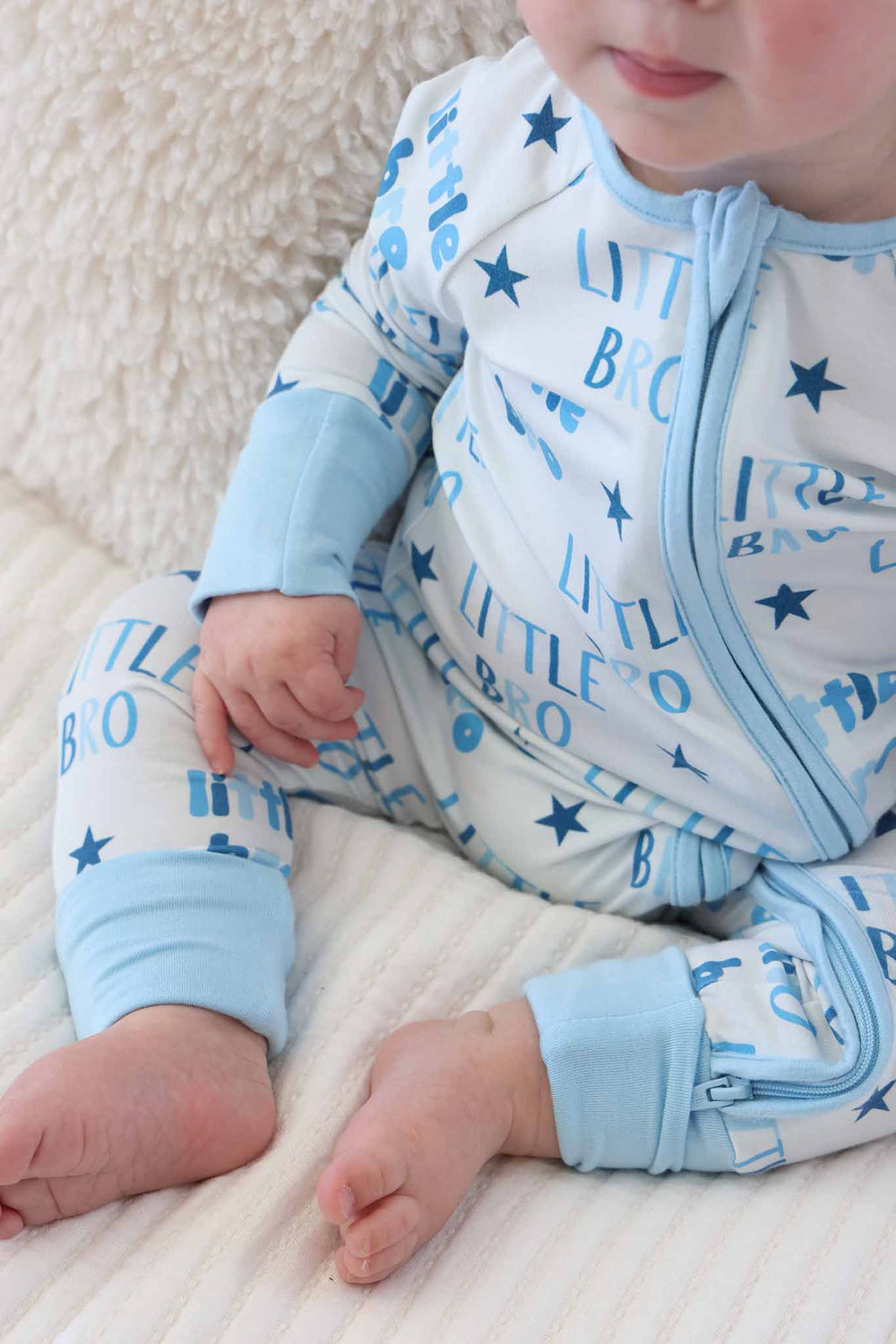 closeup of little bro convertible zip romper with flip mitts and footies 