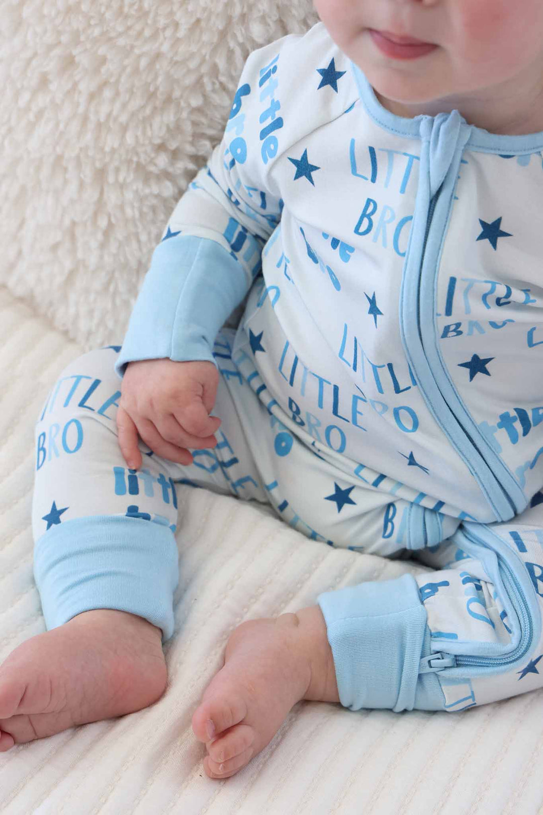 closeup of little bro convertible zip romper with flip mitts and footies 
