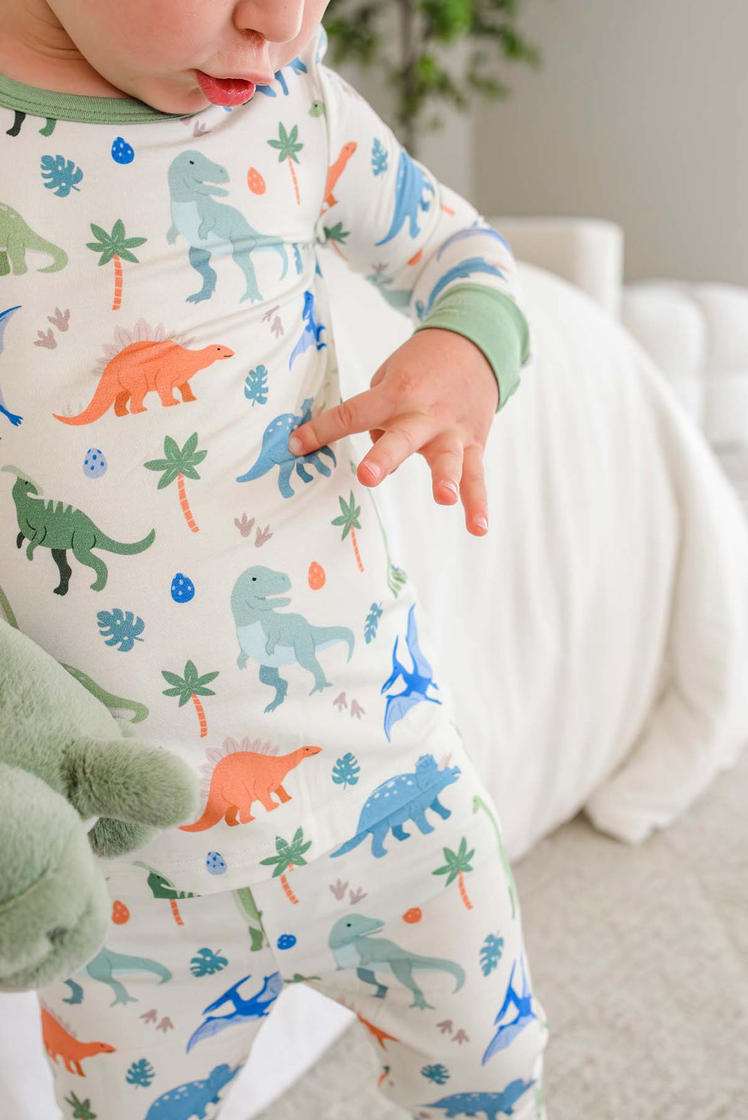 boy pointing to dinosaur on his pajamas