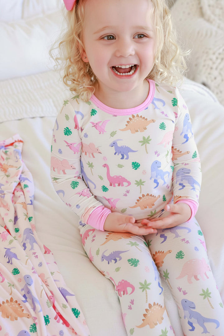 smiling girl in little fossil pink two piece pajama set