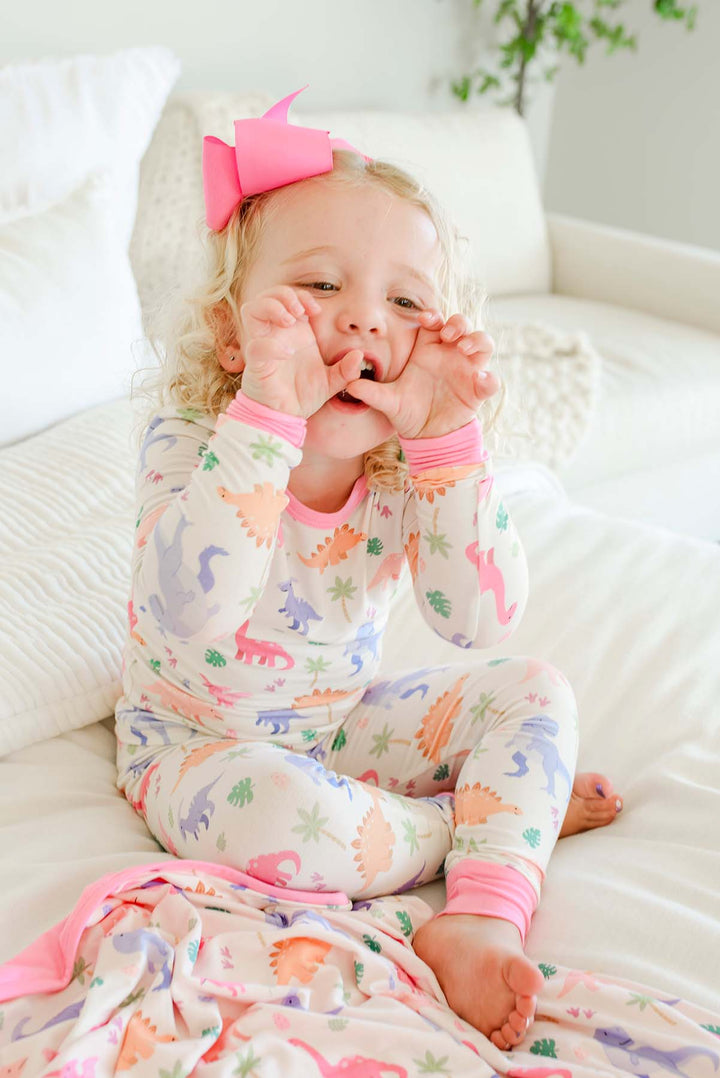 girl roaring in little fossil two piece pajama set for girls with pink ribbon bow