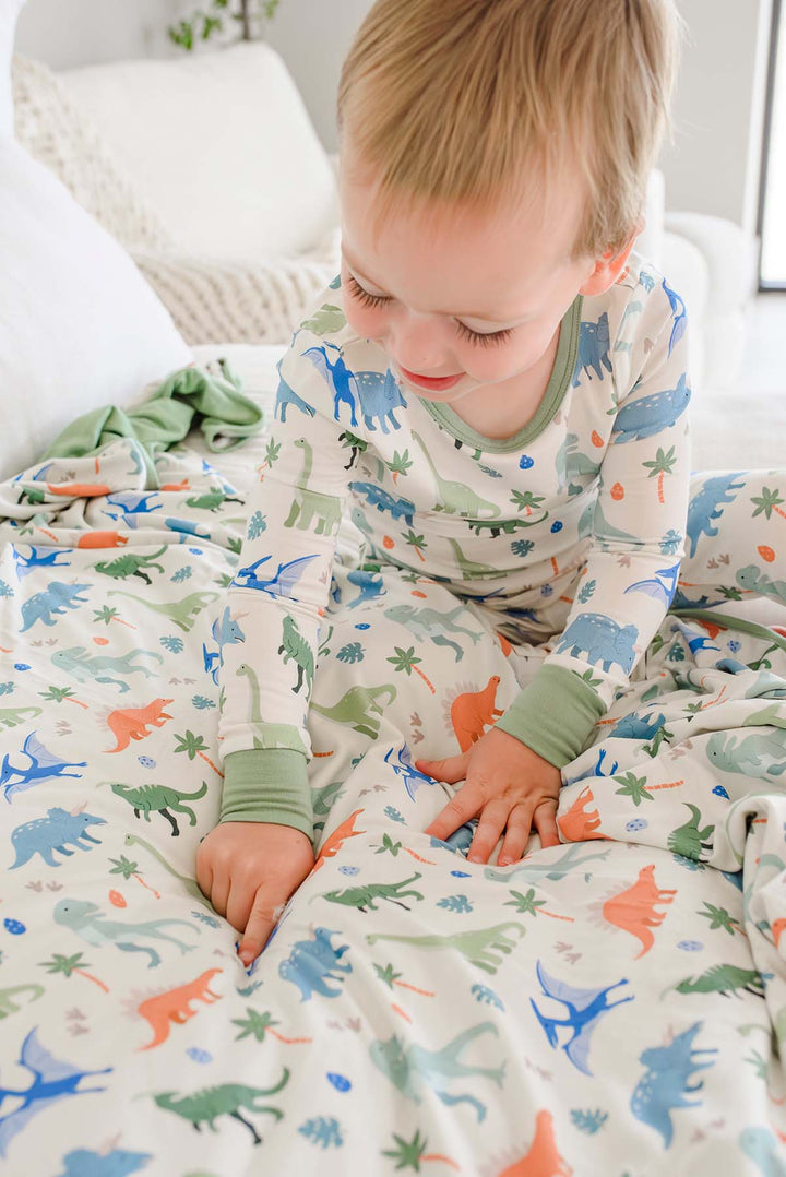 blue, green and orange dinosaur pajamas and matching bamboo blanket