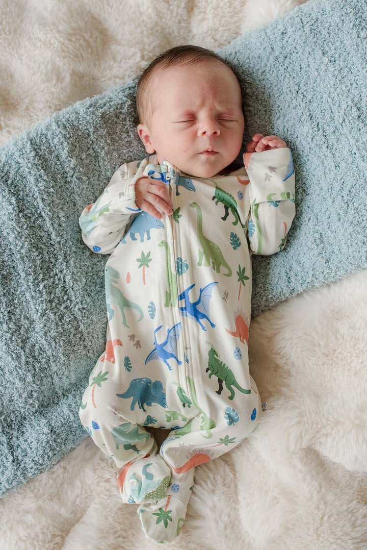sleeping baby boy in dinosaur bamboo footie pajama 