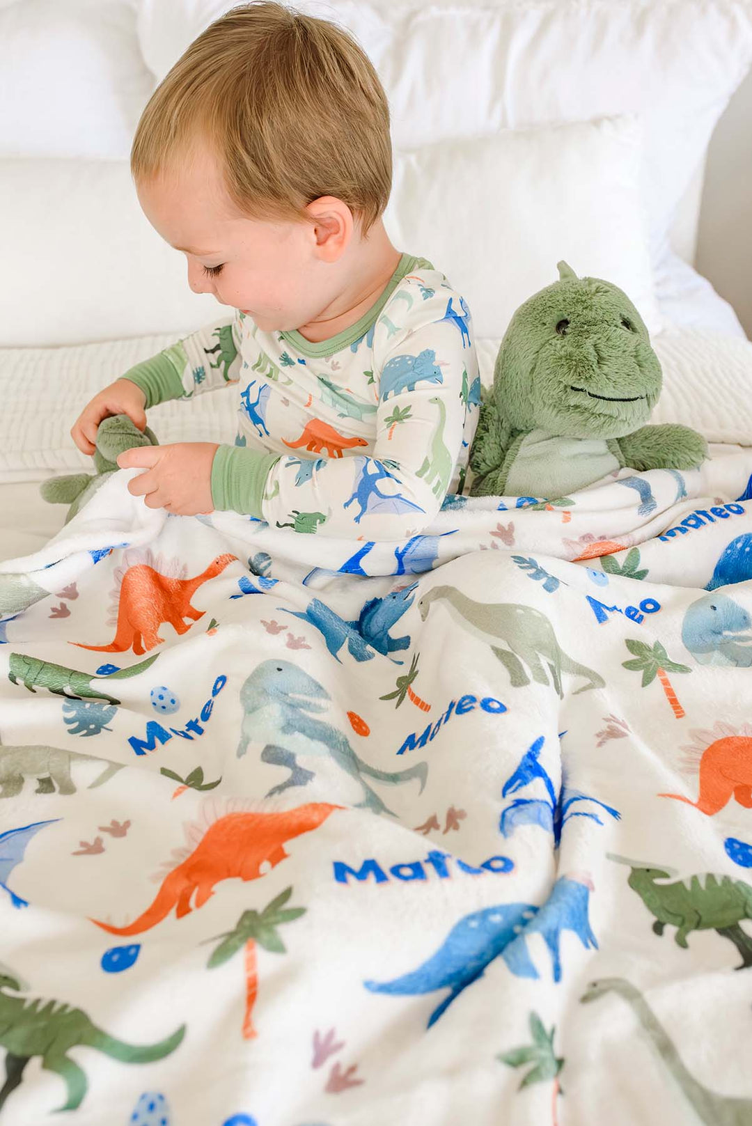 little fossil personalized blanket with blue, orange and green dinosaurs