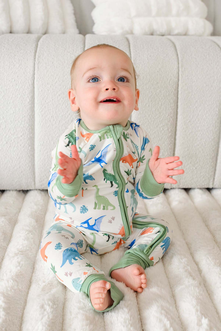 clapping baby boy in little fossil neutral convertible zip romper