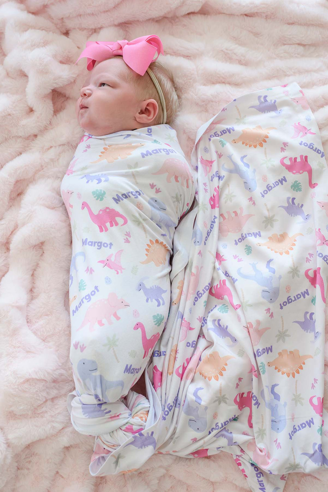 baby wrapped in little fossil personalized swaddle blanket for baby girls 