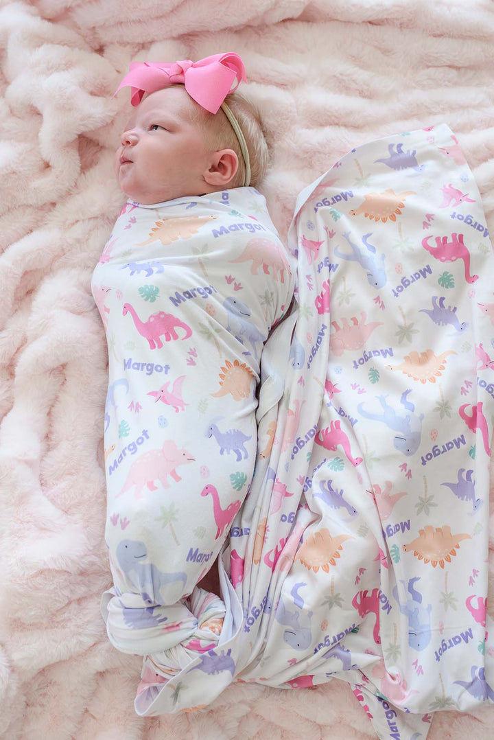baby wrapped in little fossil personalized swaddle blanket for baby girls 