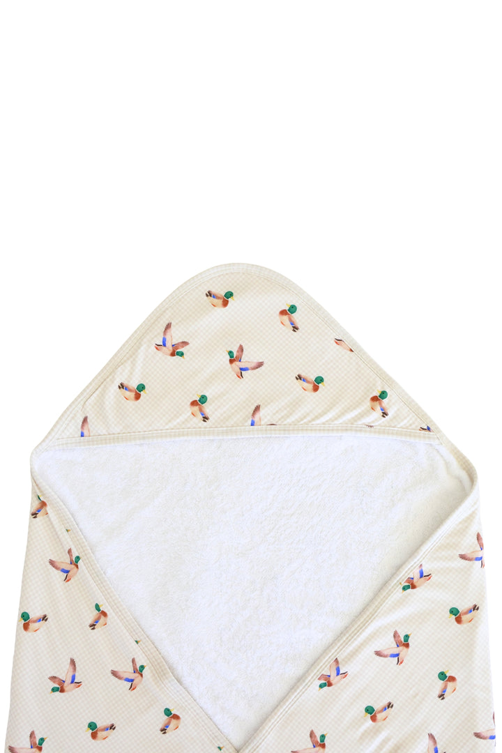 Flat lay of open little mallard duck print bamboo hooded towel showing mallard duck print exterior and white terry cloth interior