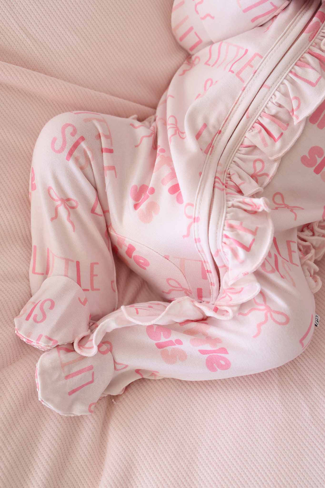 closeup of little sis ruffle zipper footie pajama for baby girls 