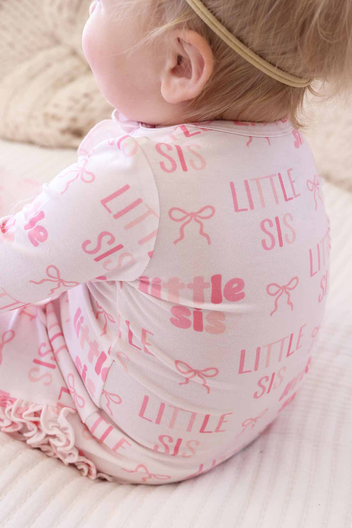 closeup of pink little sis bow ruffle footie pajama 