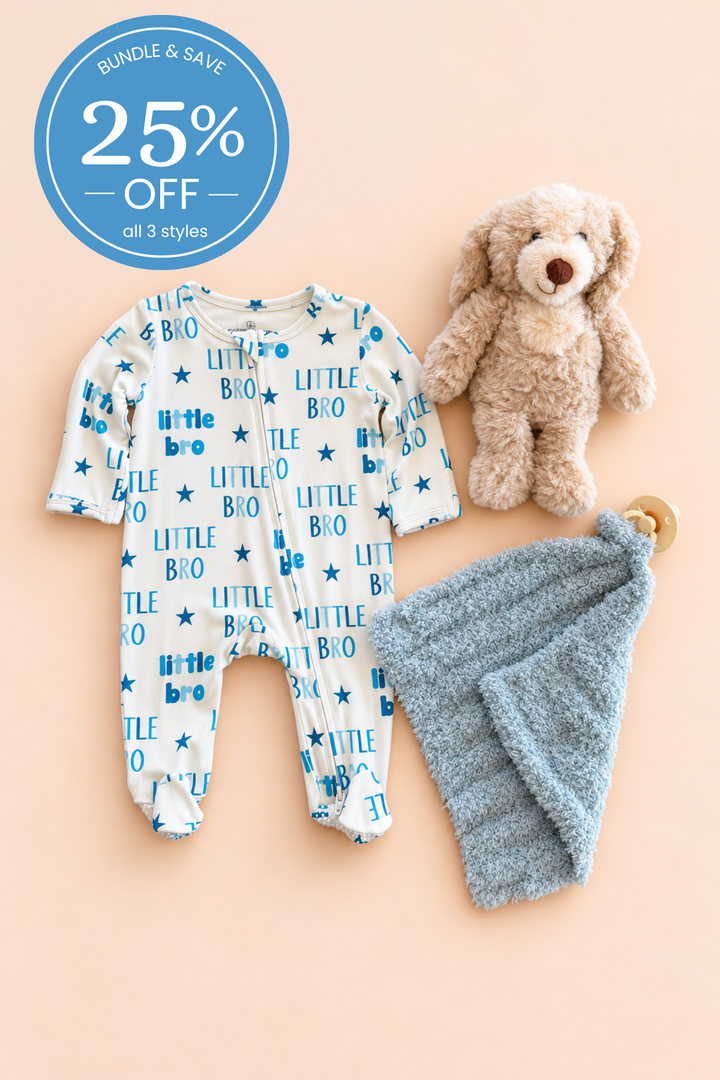A baby gift set featuring a Caden Lane white long-sleeve footed sleeper with blue &