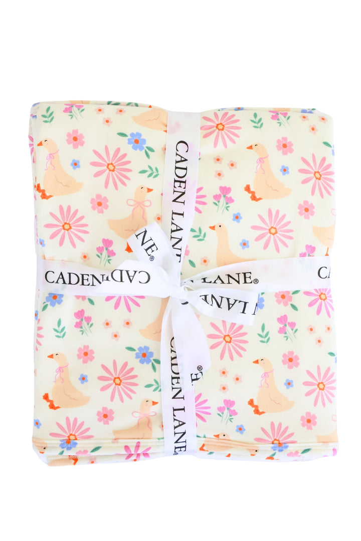 Lucy Goosy Embroidered Bamboo Hooded Towel folded and tied with a Caden Lane ribbon, showing the full duck and floral print pattern on a white background