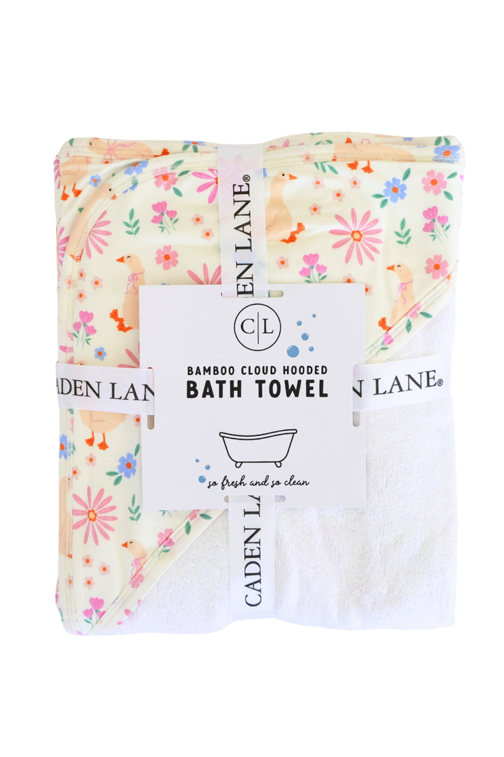 Lucy Goosy Embroidered Bamboo Hooded Bath Towel in retail packaging, showing the duck and floral print folded with a Caden Lane branded paper band on a white background