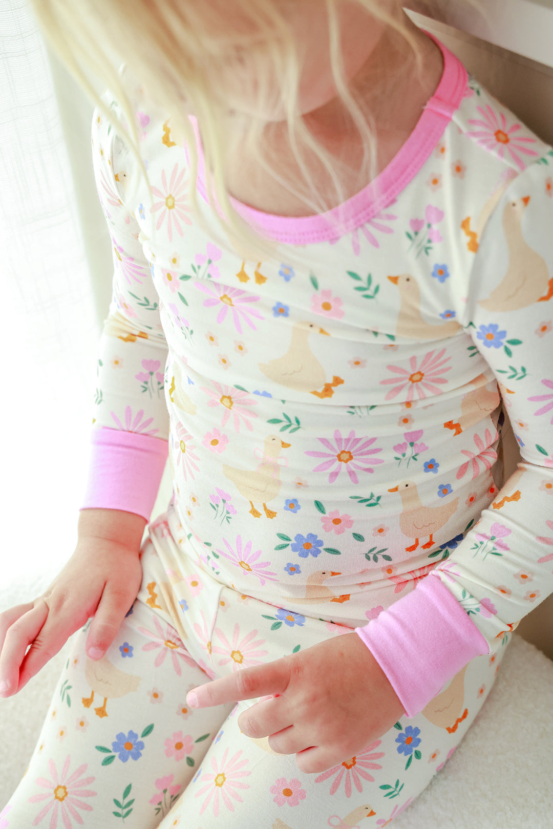 Detail view of the Lucy Goosy Two Piece Pajama Set top showing the floral duck print and pink neckline and cuff trim detail