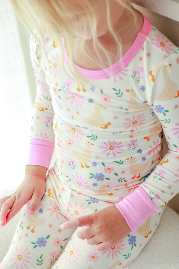 Detail view of the Lucy Goosy Two Piece Pajama Set top showing the floral duck print and pink neckline and cuff trim detail