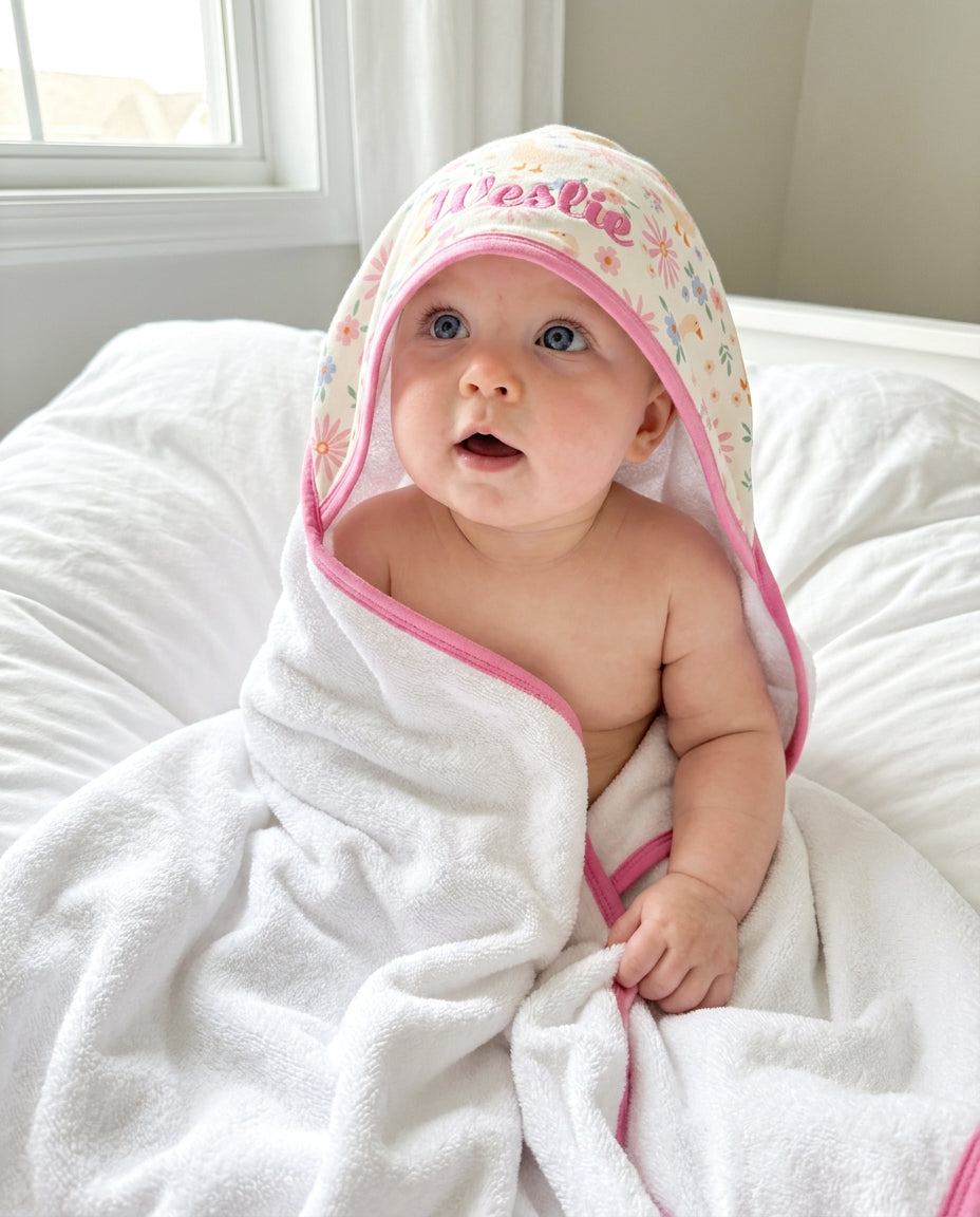 Lucy Goosy Bamboo Cloud Hooded Bath Towel in retail packaging, showing the duck and floral print folded flat with a Caden Lane branded paper band on a white background
