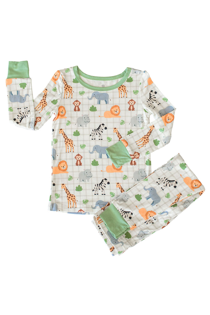 Flat lay of a Caden Lane two-piece pajama set in a Wild Child print featuring safari animals on cream plaid, with a sage green neckline and cuffs.